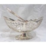 A 16.5cm silver oval pedestal basket with swing handle and pierced scroll decoration by John Round