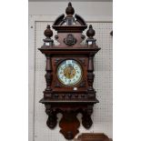 A Victorian mahogany ornate wall clock with high pediment finials and applied roundel, decorative