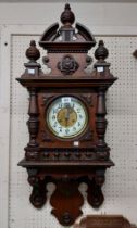 A Victorian mahogany ornate wall clock with high pediment finials and applied roundel, decorative