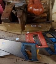 A wooden box containing planes and other woodworking tools - sold with a quantity of hand saws