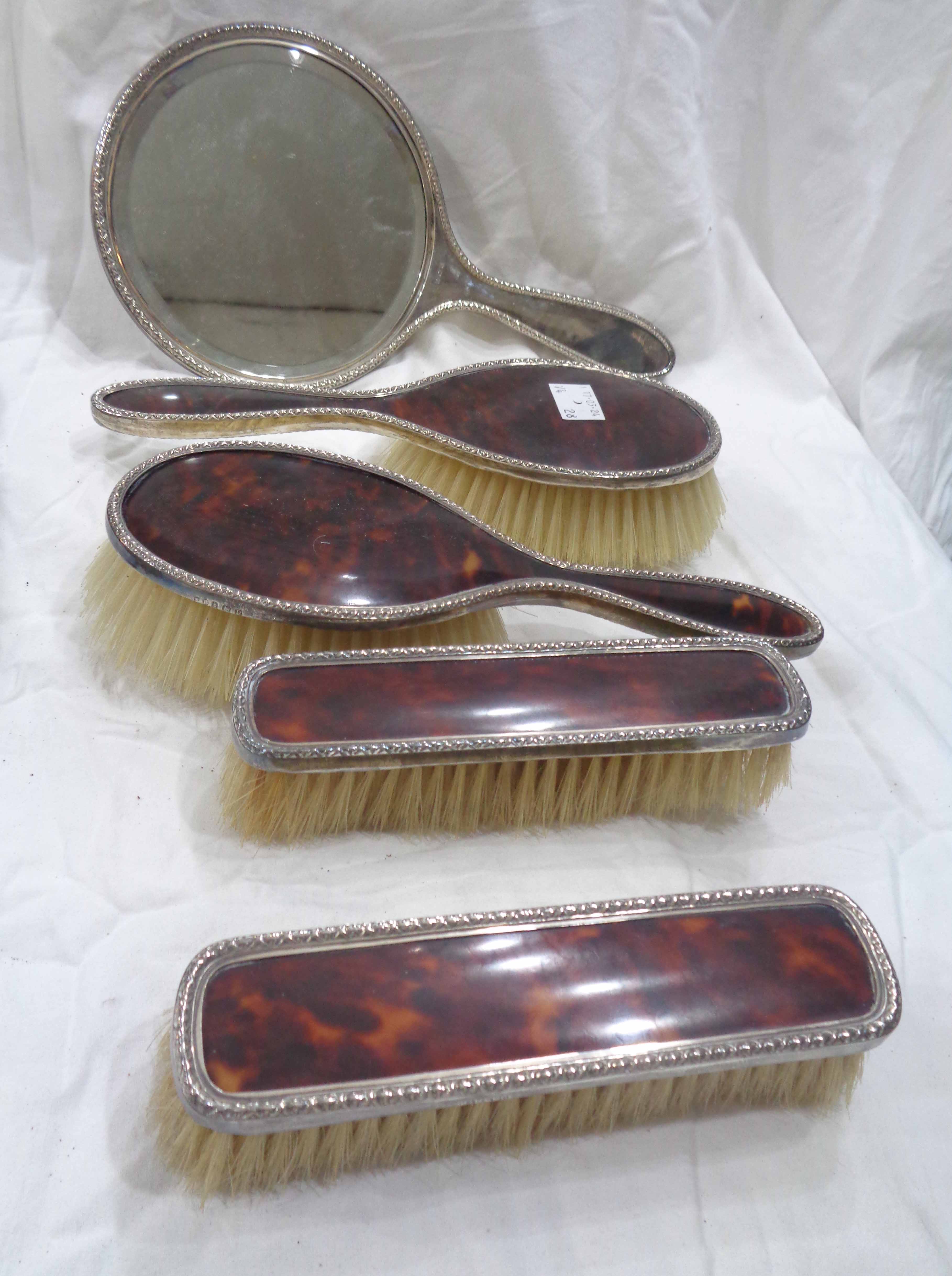 A harlequin five piece silver and tortoiseshell mounted hand mirror and brush set
