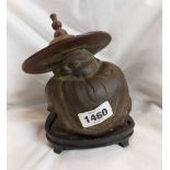 An oriental brass figure of a wise man on wooden base