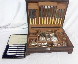 An early 20th Century polished oak canteen containing a part six place setting of silver plated