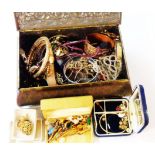 A vintage bombe biscuit tin containing a quantity of assorted costume jewellery and other items