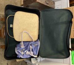 A vintage suitcase containing two travelling bags
