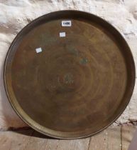 A large brass tray with etched Middle Eastern design