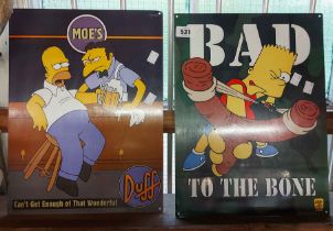 Two modern Simpson signs, one depicting Moe's Bar, the other Bart Simpson with a sling shot