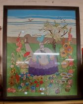 A large vintage framed needlework of lady tending to a garden