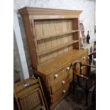 A 1.65m waxed pine two part dresser with two shelf open plate rack over a base with two short and