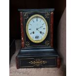 A late Victorian black slate and red marble cased mantel clock with Aesthetic incised and gilded