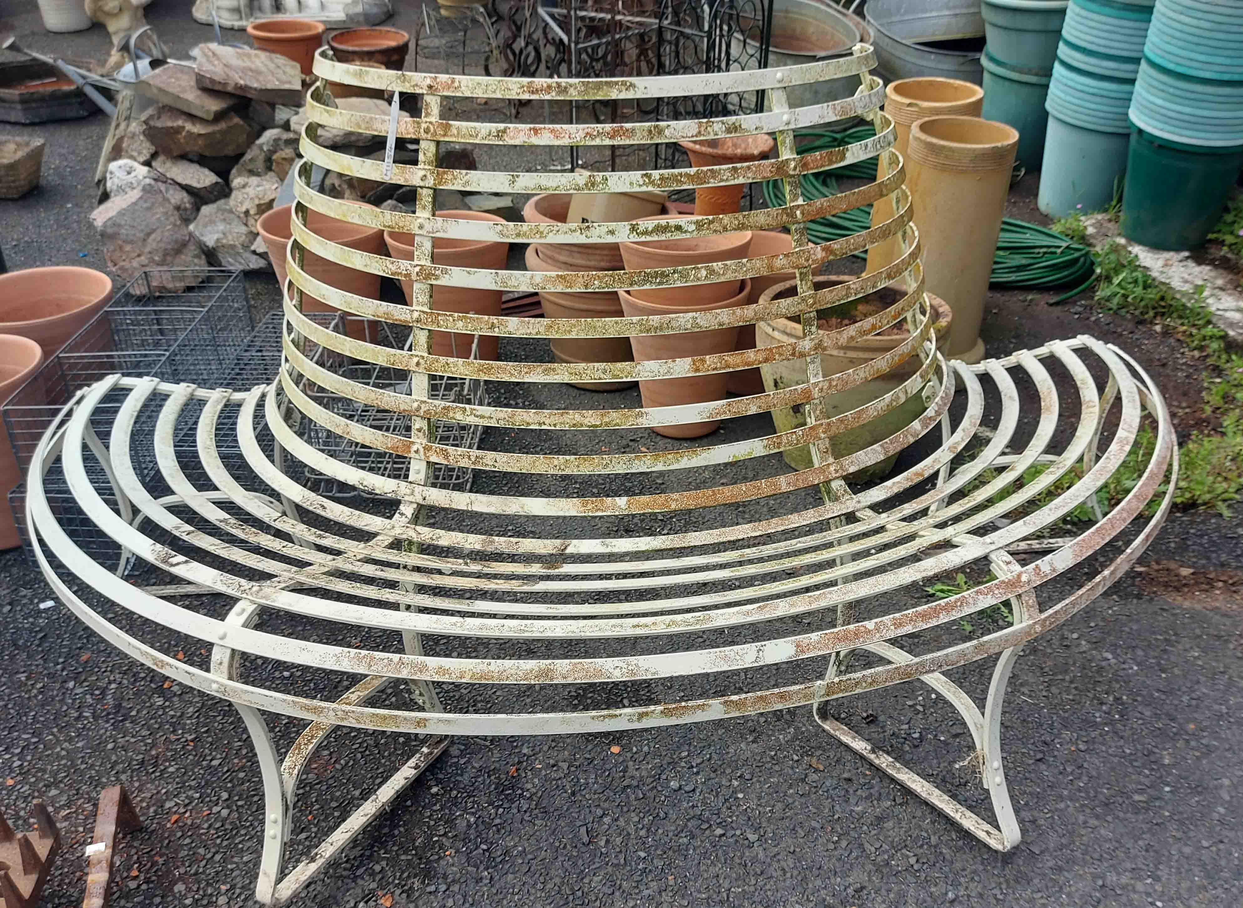 A two part wrought iron circular tree bench