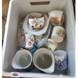 A crate containing a quantity of ceramics including jugs, commemorative china, etc.