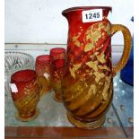 A late 19th Century 'Amberina' glass lemonade set comprising a tall jug and six mug form glasses,