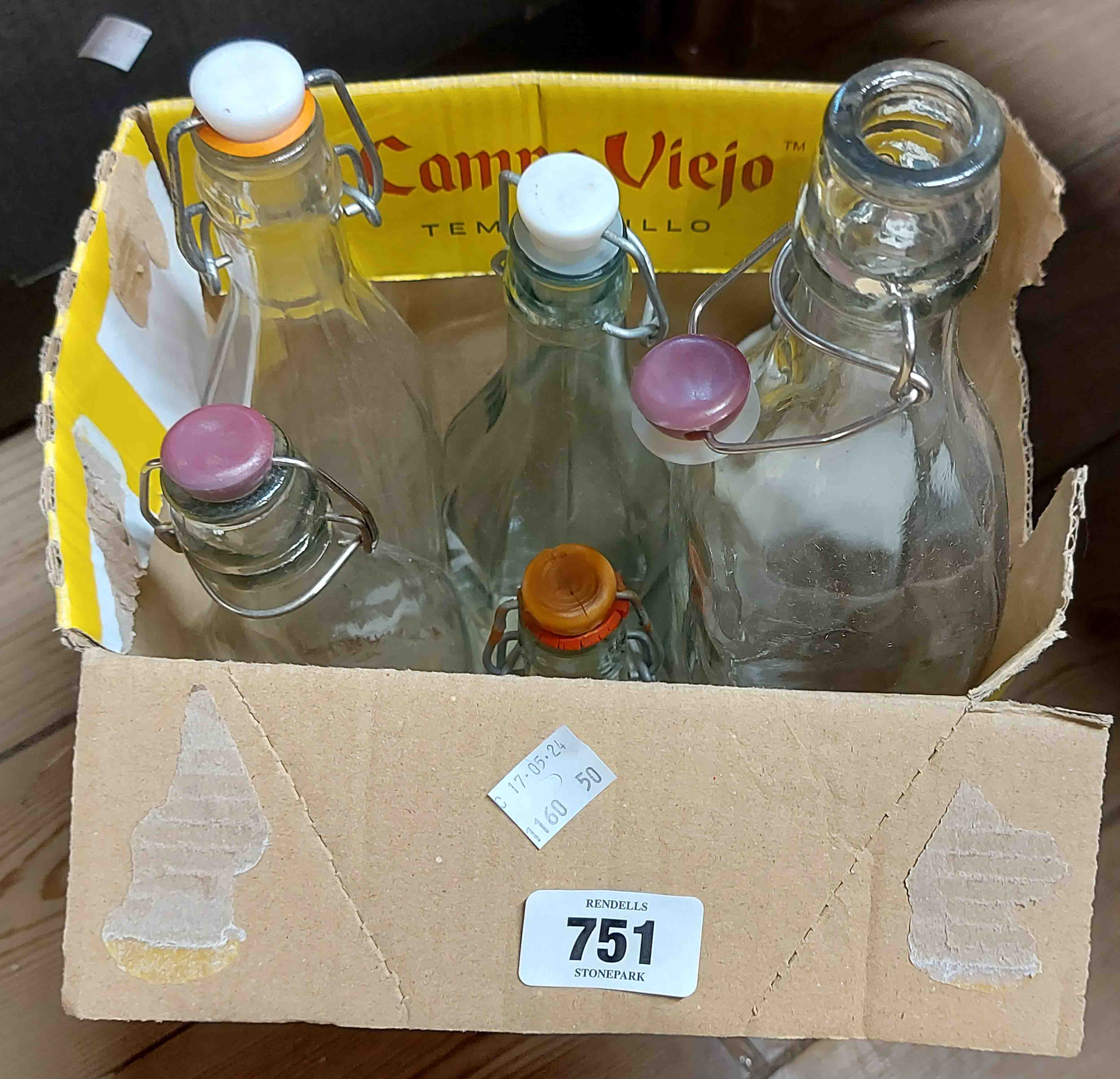 A box containing six vintage style bottles with stoppers bottles