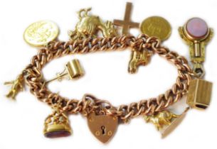 A marked 9c rose metal kerb-link charm bracelet with 375 (9ct.) heart shaped locket and set with