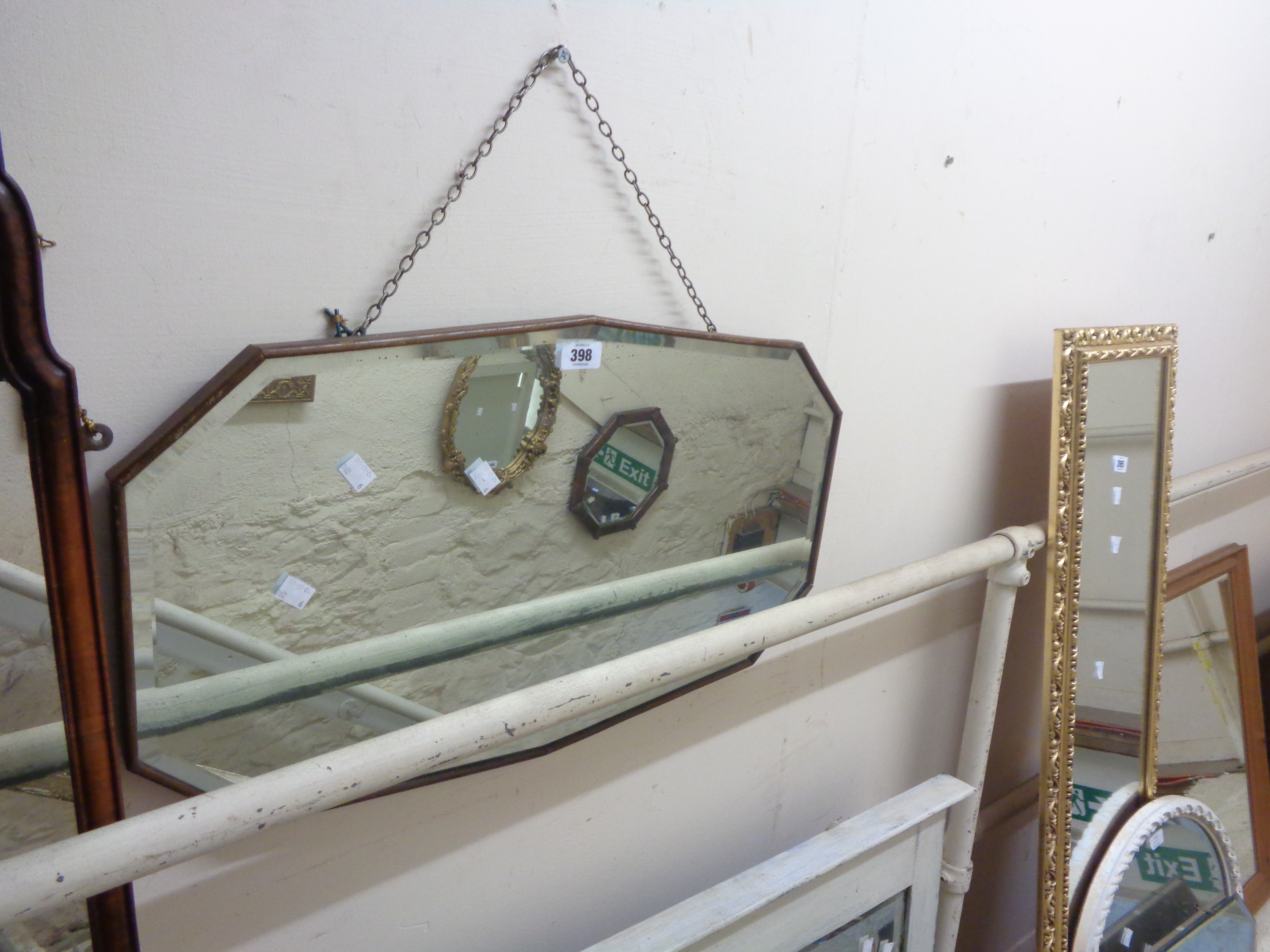 A vintage wall mirror with shaped bevelled plate