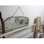 A vintage wall mirror with shaped bevelled plate
