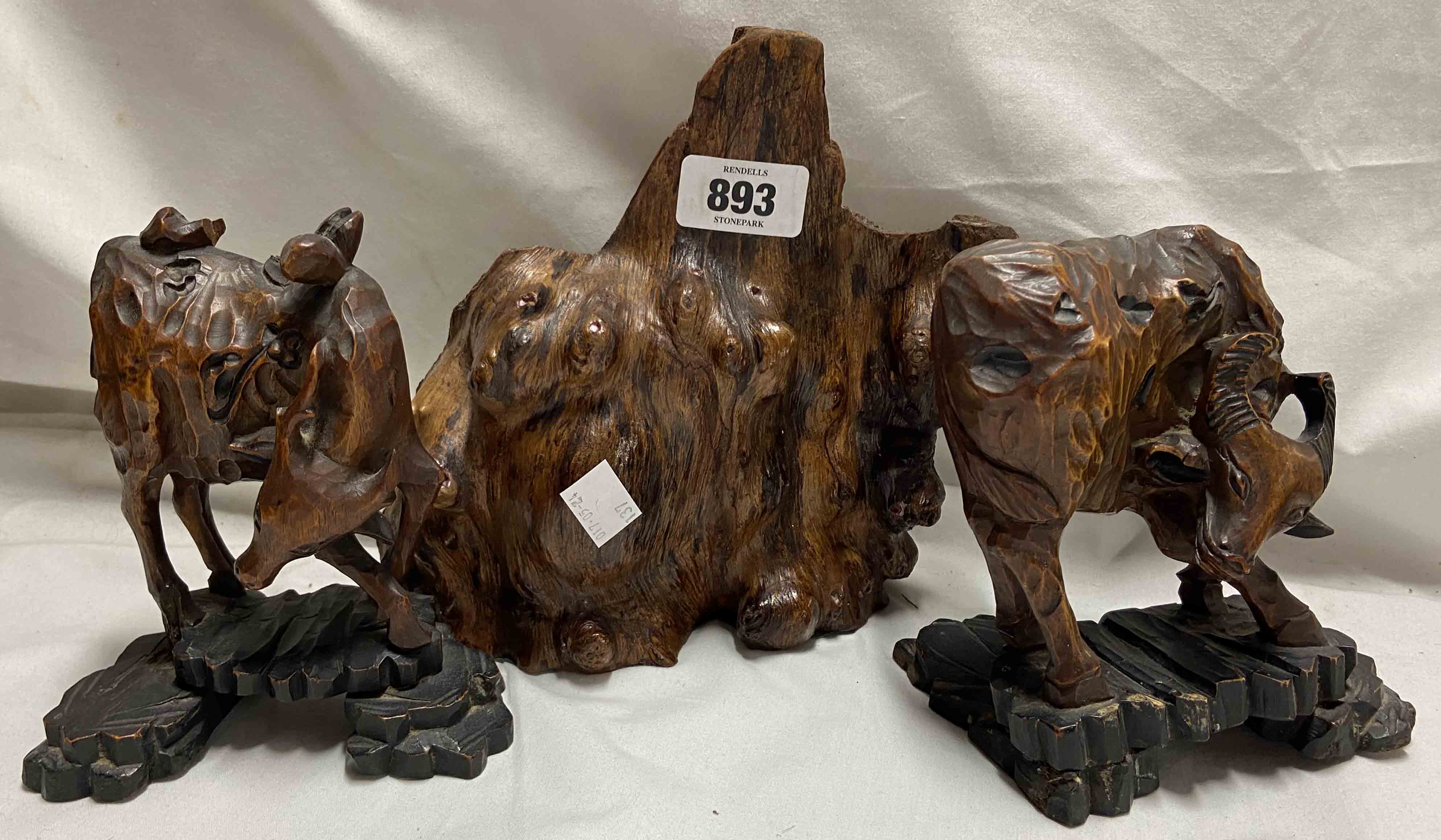 Three wooden decorative items comprising two carved hardwood figures, depicting an Ox and a Deer (