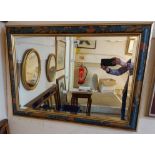 A large modern painted framed bevelled oblong wall mirror