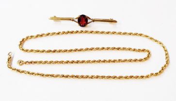A marked 9KT yellow metal rope twist neck chain - sold with a 9ct. gold garnet set bar brooch