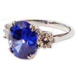 A hallmarked 950 platinum ring, set with central 5.38ct. oval tanzanite flanked by two diamonds -