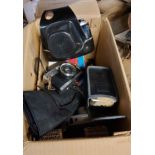 A box containing a quantity of vintage cameras, filters, etc. including a Milonta Hi-matic camera,