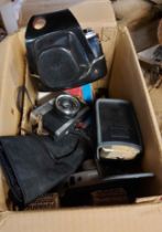 A box containing a quantity of vintage cameras, filters, etc. including a Milonta Hi-matic camera,