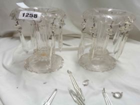 A pair of 19th Century cut glass lustres with some drops in place and a bag containing further