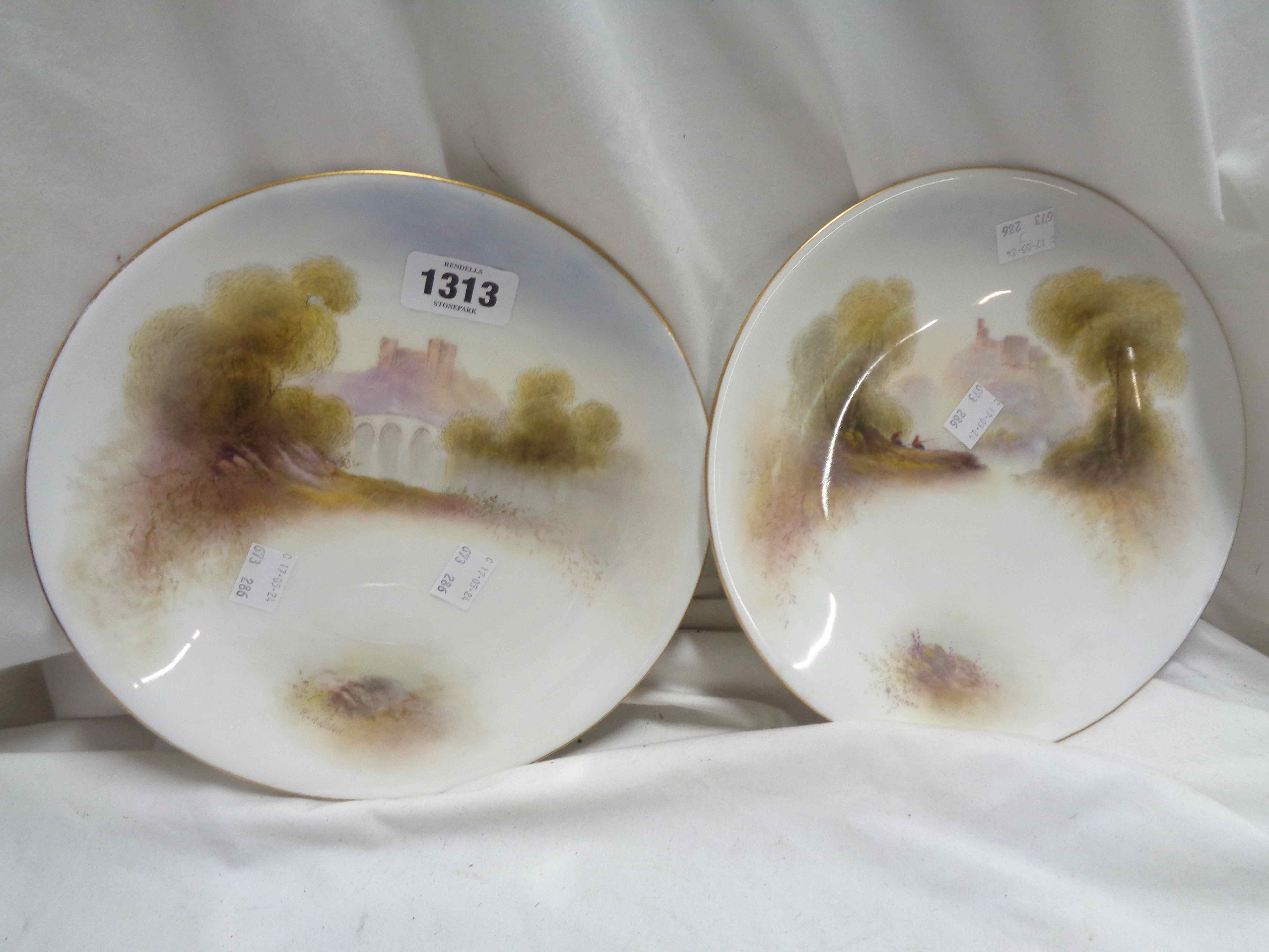 A pair of Royal Worcester porcelain cabinet plates with hand painted scenes by Raymond Rushton