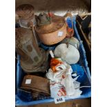 A blue crate containing old paraffin lamps, etc.