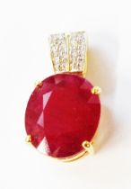 A marked 750 yellow metal pendant, set with oval heat treated ruby with tiny diamonds to suspender