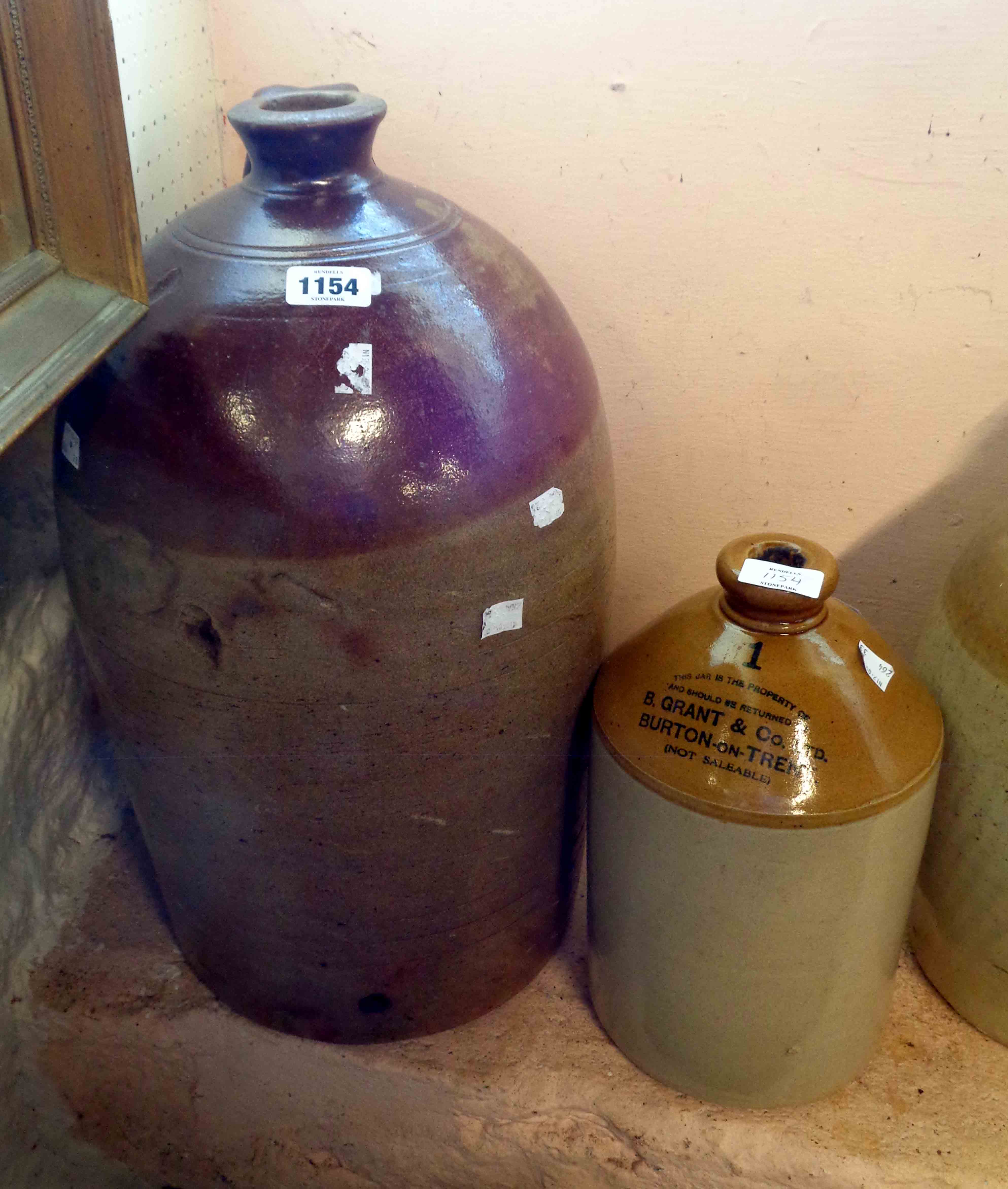 A large antique saltglazed stoneware flagon - later drilled hole for wooden spigot and old repair to