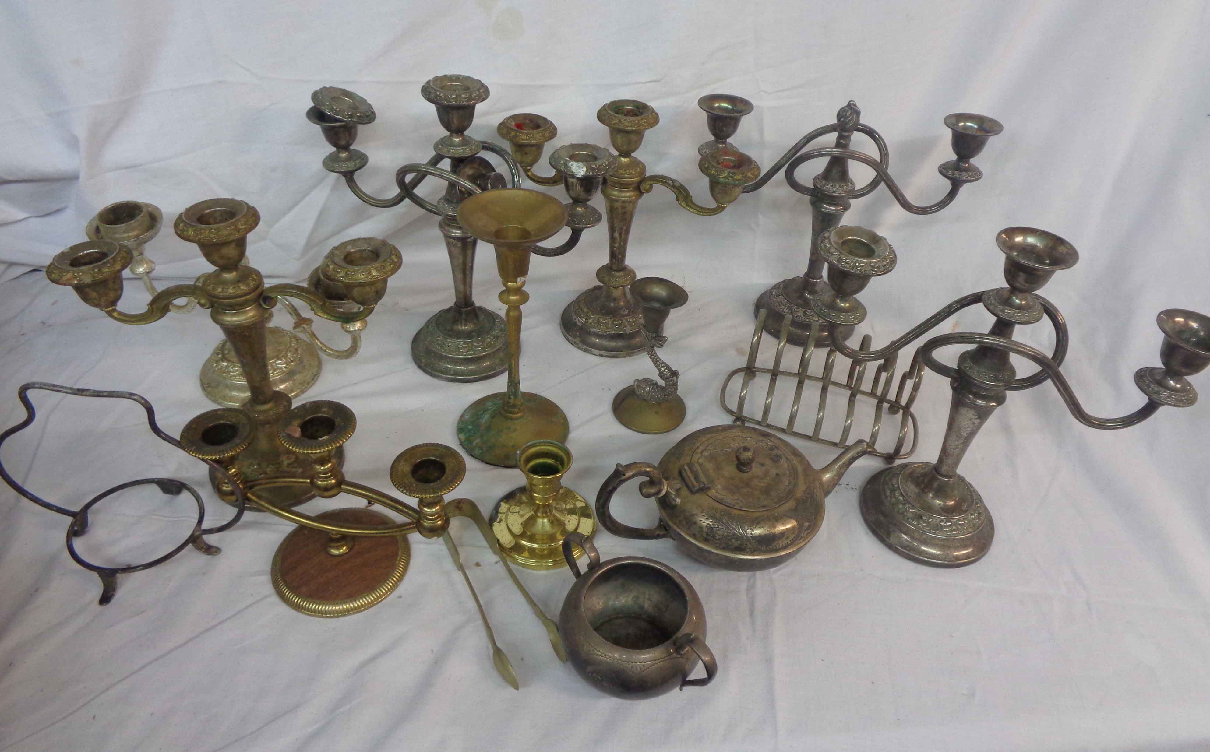 A box containing a quantity of silver plated items including candlesticks, teaware, etc.