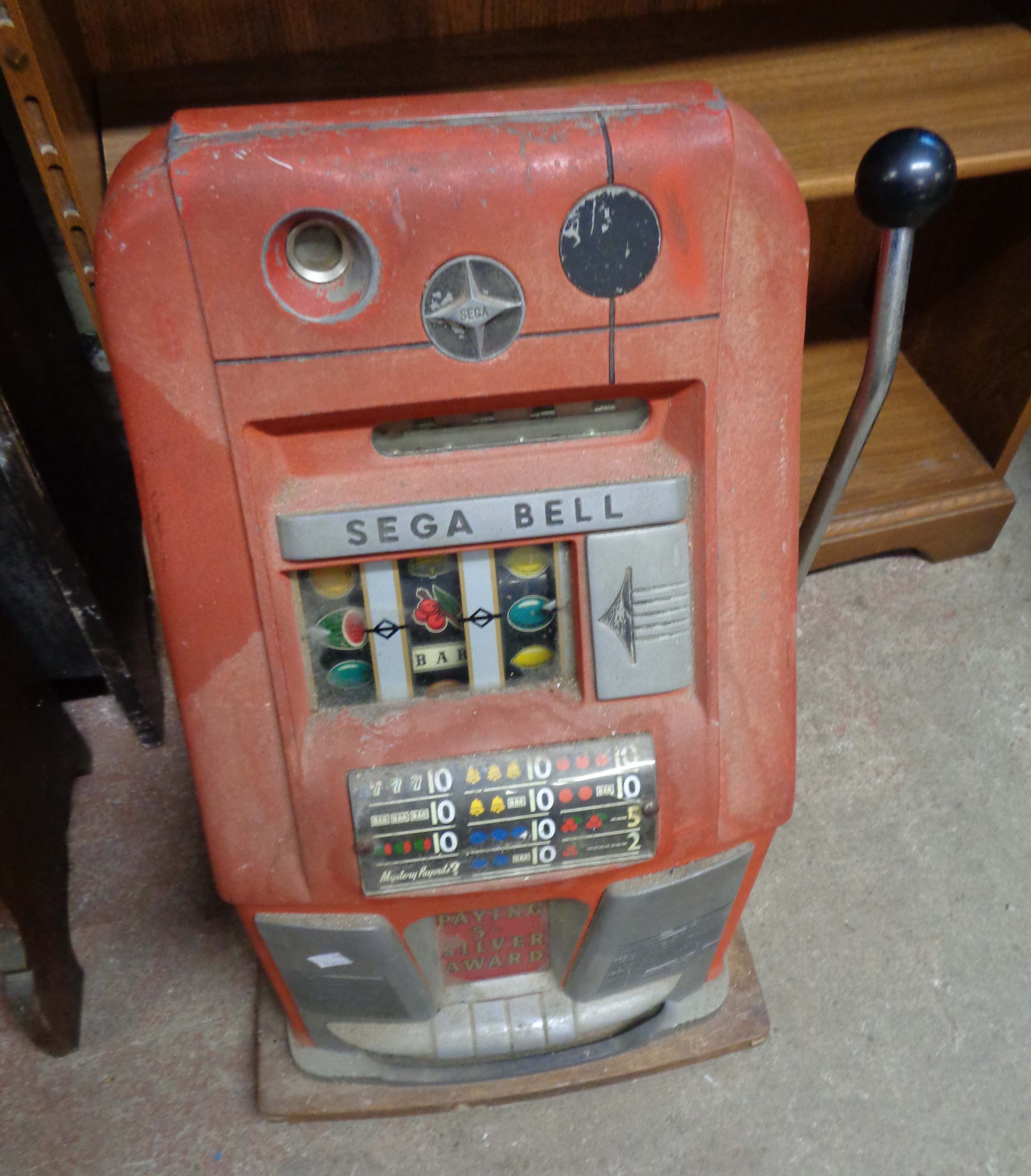 A vintage Sega Bell 'One Armed Bandit' fruit machine with red and chrome finish