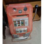 A vintage Sega Bell 'One Armed Bandit' fruit machine with red and chrome finish