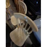 A set of four modern blonde wood lathe back kitchen chairs - sold with a pierced splat back similar