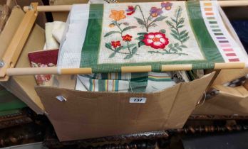 A box containing a quantity of antique bed linen and tapestry frame