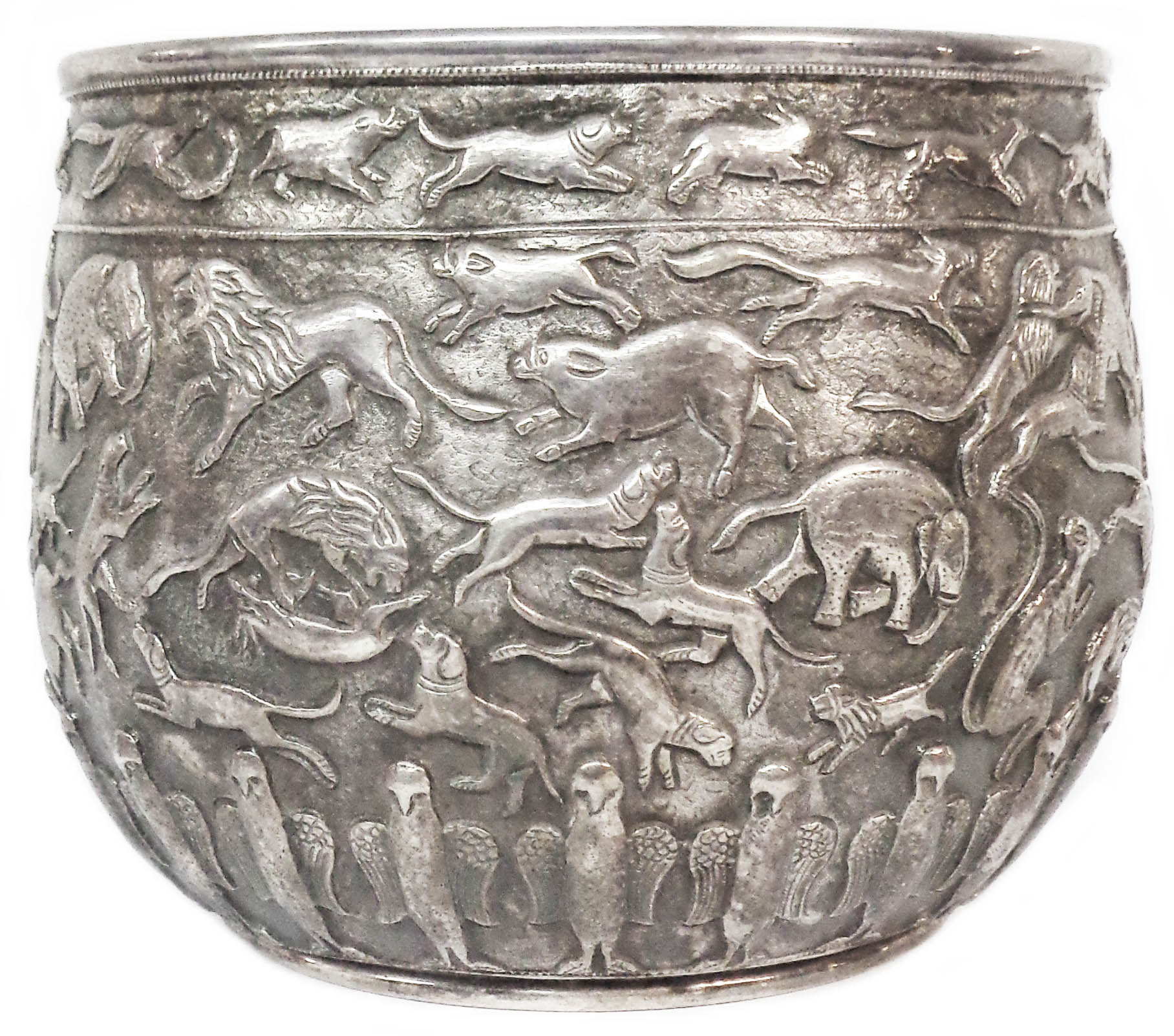 A 14.75cm high Anglo-Indian white metal jardinière with profuse embossed animal and bird decoration