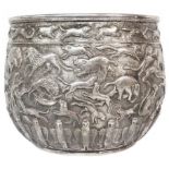 A 14.75cm high Anglo-Indian white metal jardinière with profuse embossed animal and bird decoration