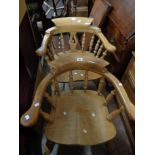 Two similar smoker's bow elbow chairs, both with moulded solid elm seats, set on turned supports