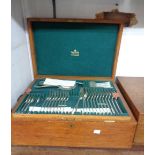 A vintage oak canteen containing a part twelve place setting of Mappin & Webb silver plated cutlery
