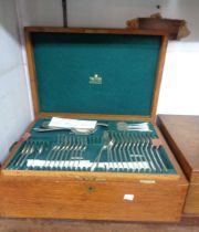 A vintage oak canteen containing a part twelve place setting of Mappin & Webb silver plated cutlery