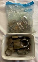 A bag containing a quantity of antique keys - sold with a tub containing assorted padlocks