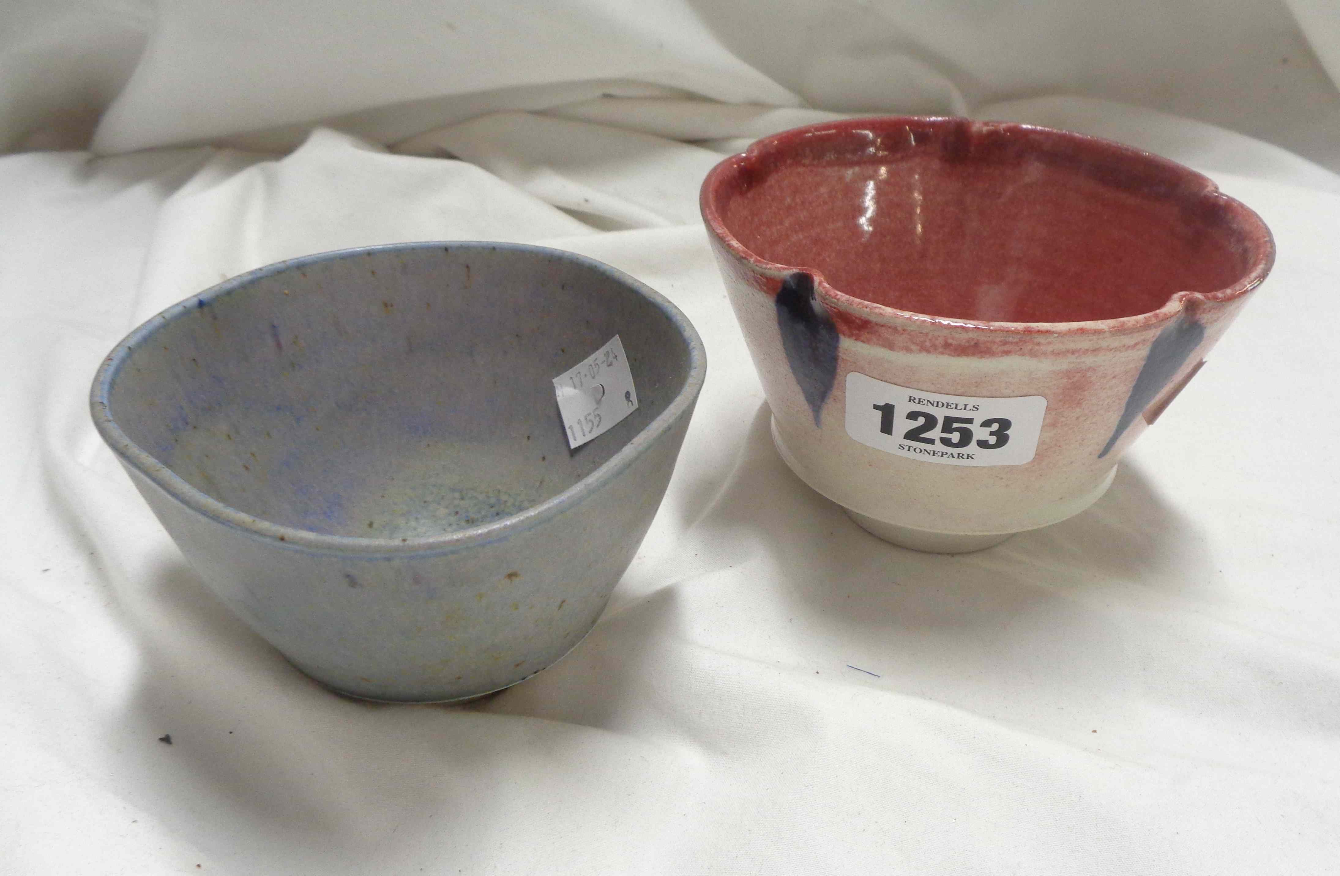 Doug Jones: a Studio Pottery bowl with pinched rim and blue painted decoration on a shaded red glaze