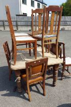 An antique mahogany table - sold with a quantity of dining chairs- for restoration
