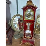 A vintage ornate burgundy and gilt resin miniature longcase timepiece with mechanical movement -