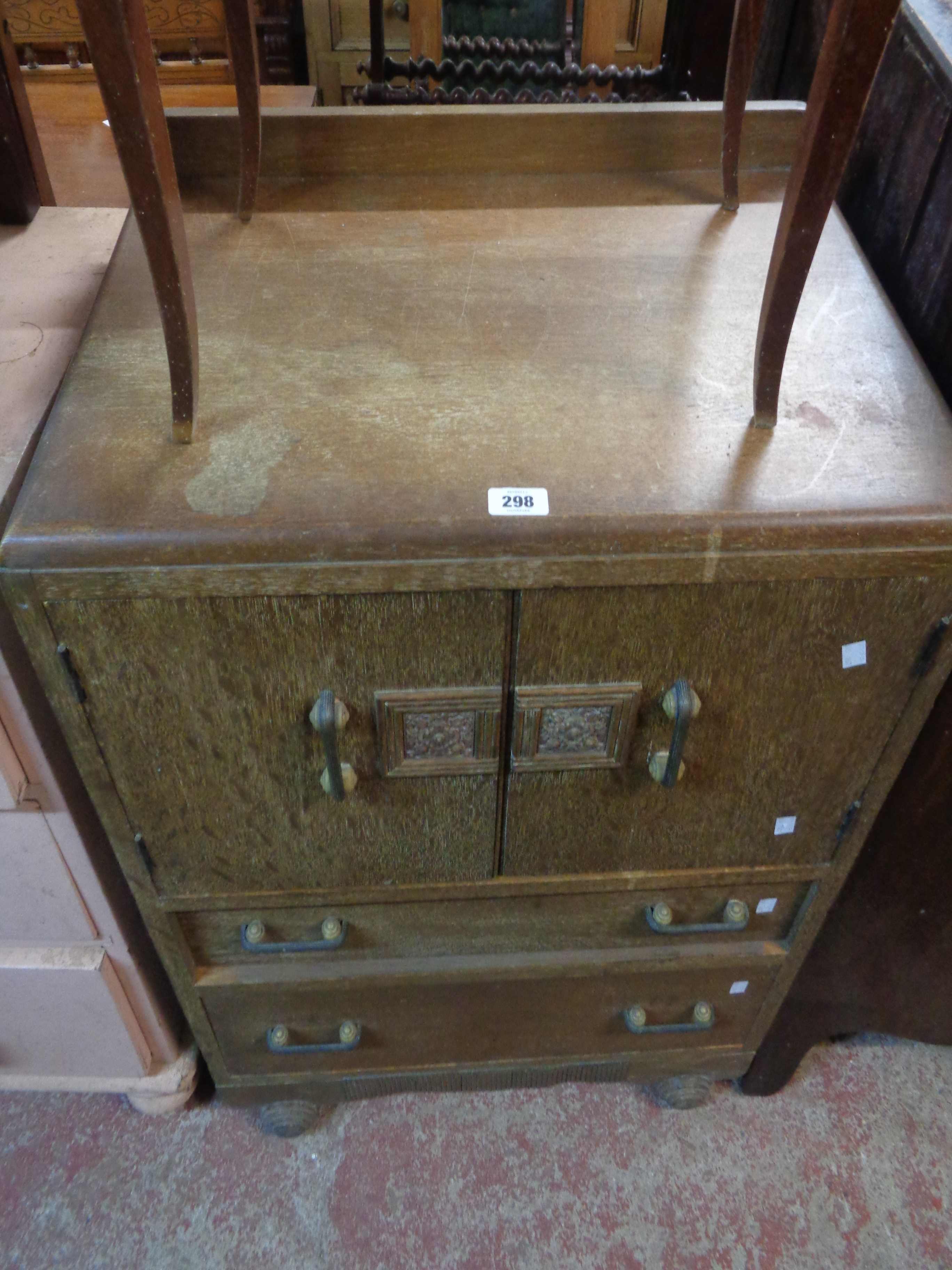 A 65cm Art Deco oak cabinet with shelves enclosed by a pair of cupboard doors over two long