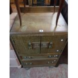 A 65cm Art Deco oak cabinet with shelves enclosed by a pair of cupboard doors over two long