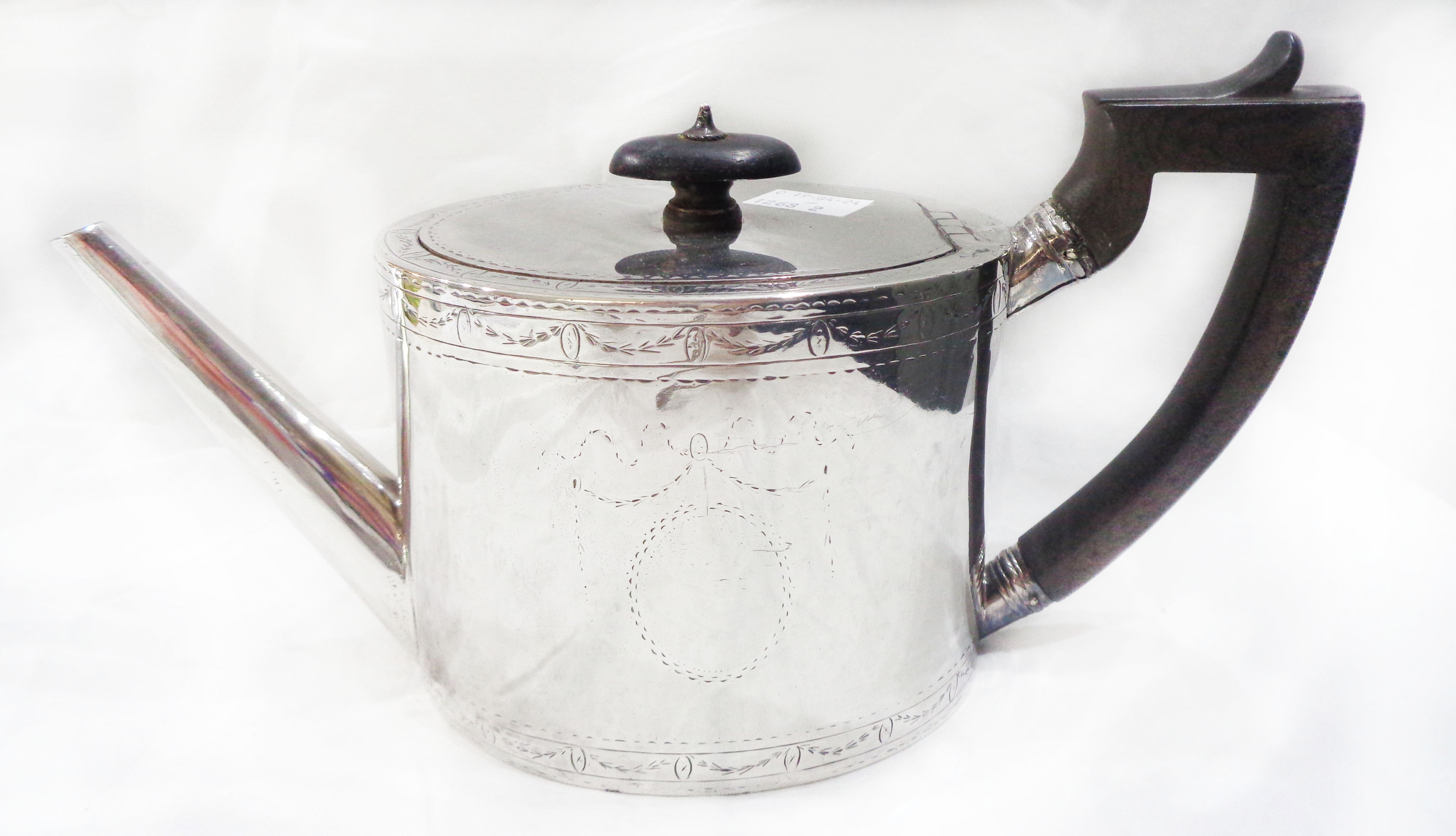 An antique silver oval teapot with ebony knop and handle (remains of chased decoration) - London