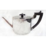 An antique silver oval teapot with ebony knop and handle (remains of chased decoration) - London